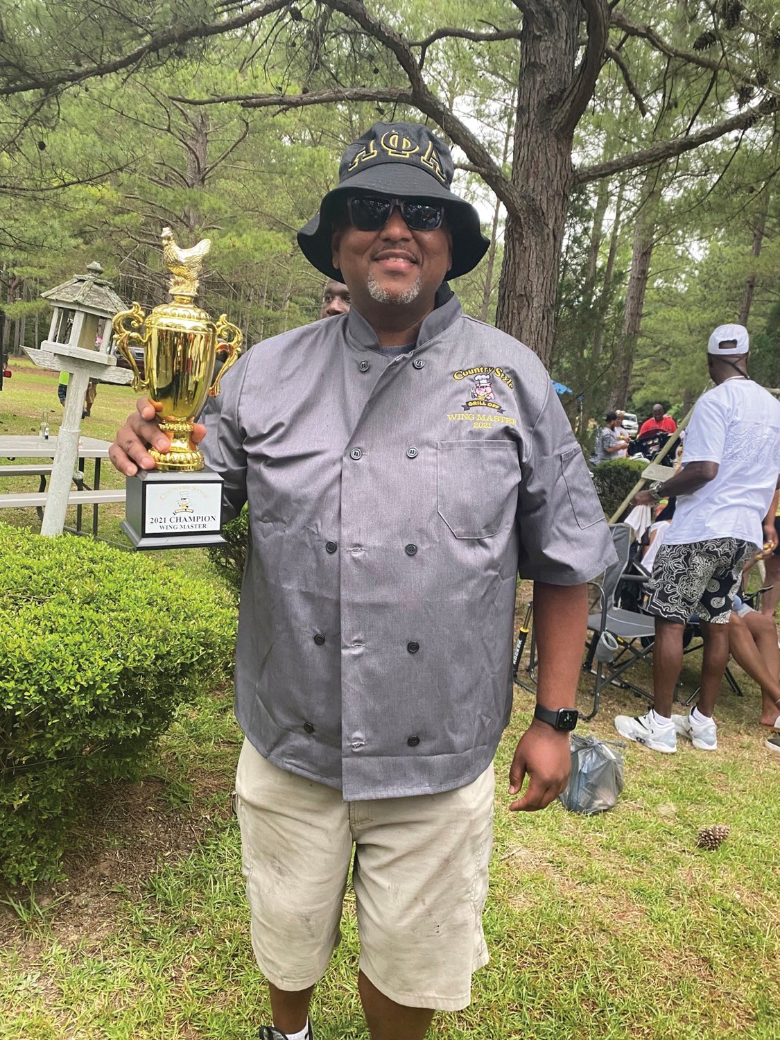 Dorian Smith holds the tropy he won as Barbecue Chicken Master at the Marlboro County Cook-off in South Carolina.