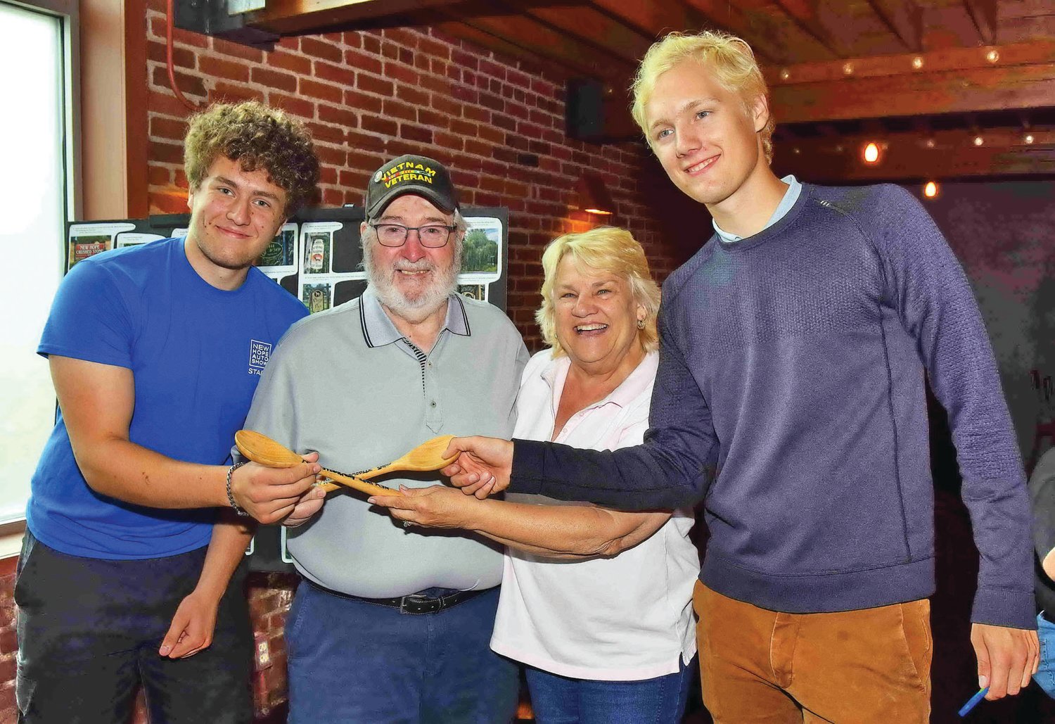 Pat and Tina Smith receive the traditional wooden spoons for finishing in last place from Rally Masters Josh Eisen and Trey Dusek.