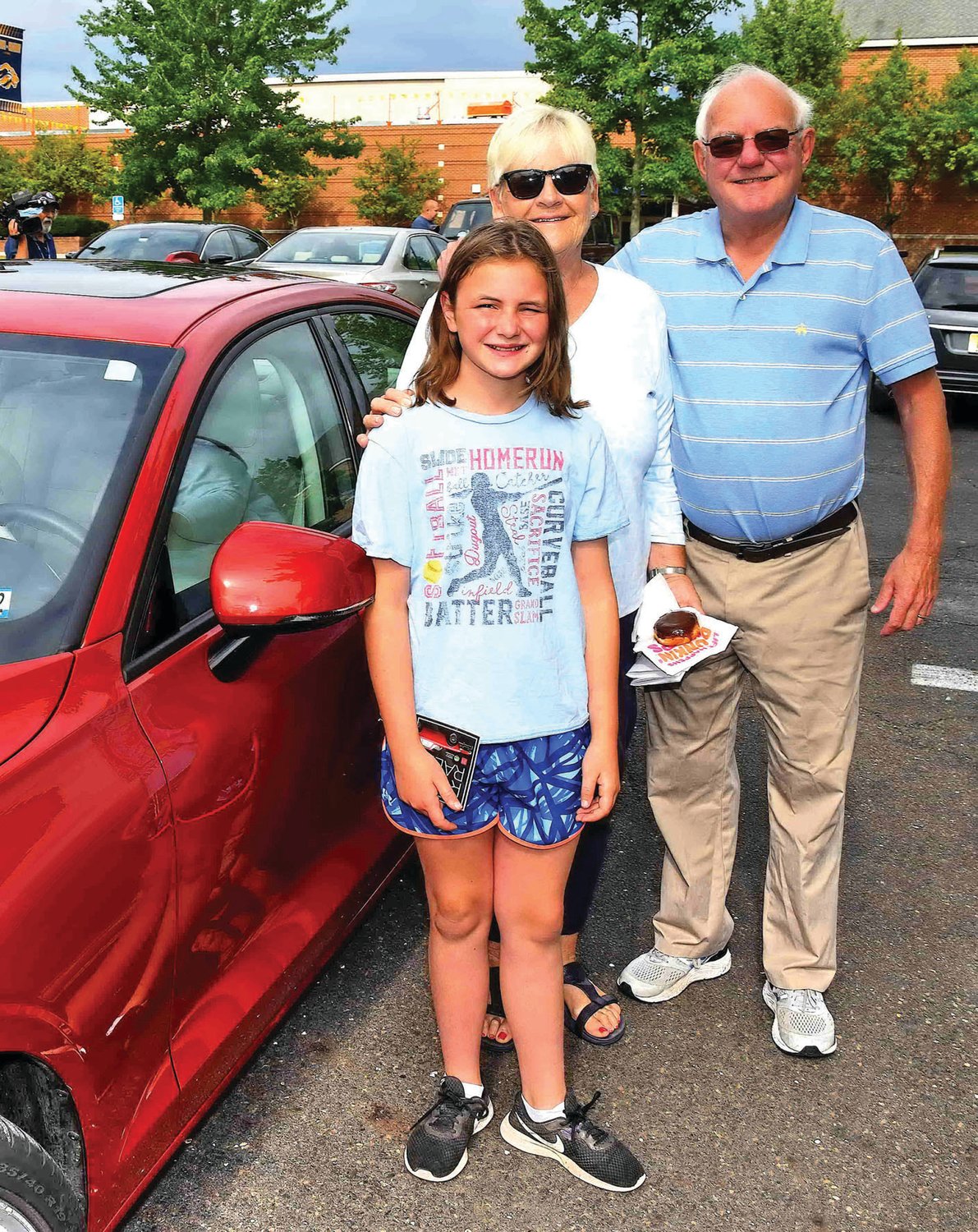 Melanie and Larry Thiel and daughter Lucy with their Volvo S60.