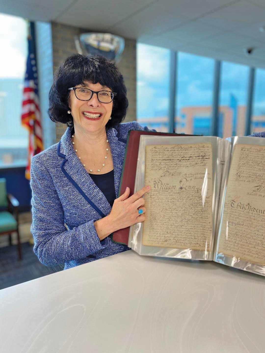 Bucks County Recorder of Deeds Robin Robinson with one of the books containing records she has had preserved using grant money. She has also expanded online access to deeds dating to 1684.