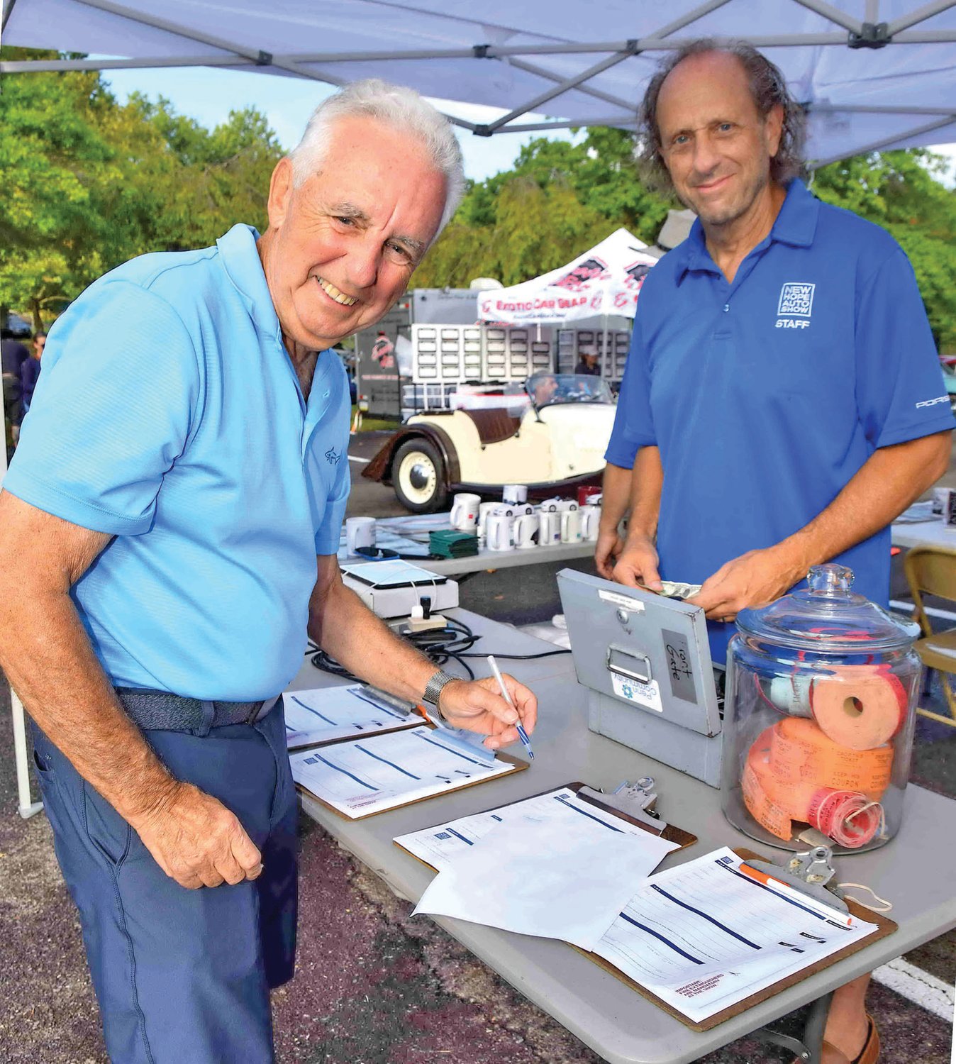 Roger Reidley registers his vehicle for the New Hope Automobile Show as staff member Steve Williams looks on.
