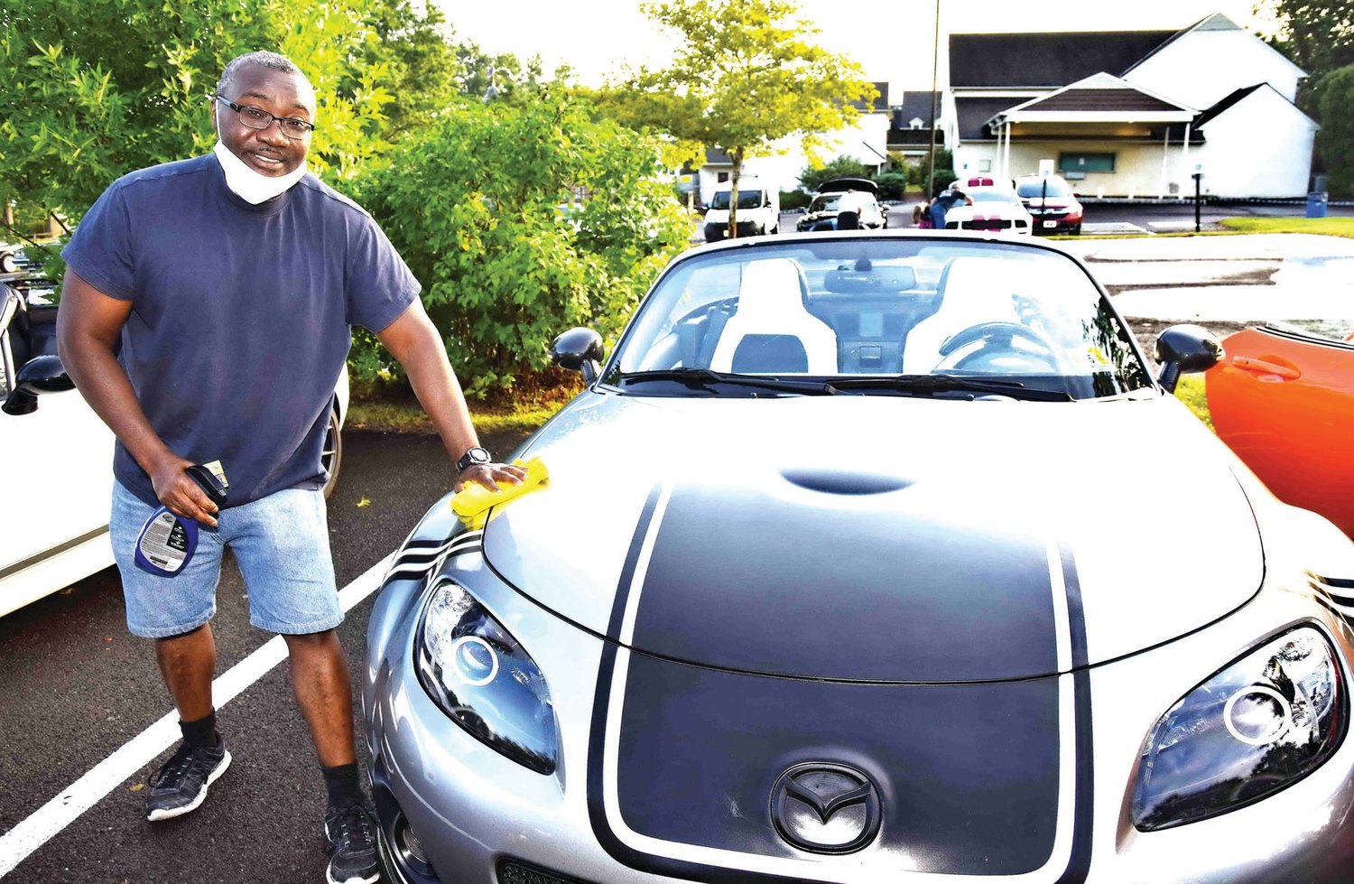 David Yeboah polishes his 2012 Mazda Miata.