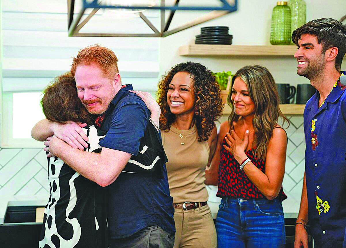 Jesse Tyler Ferguson, star of “Modern Family,” gets a hug.  He visited Montgomery, Texas, and surprised Broadway friend Kevin Cahoon and his mother Reesa Cahoon, with a home makeover for “Secret Celebrity Renovation.”
