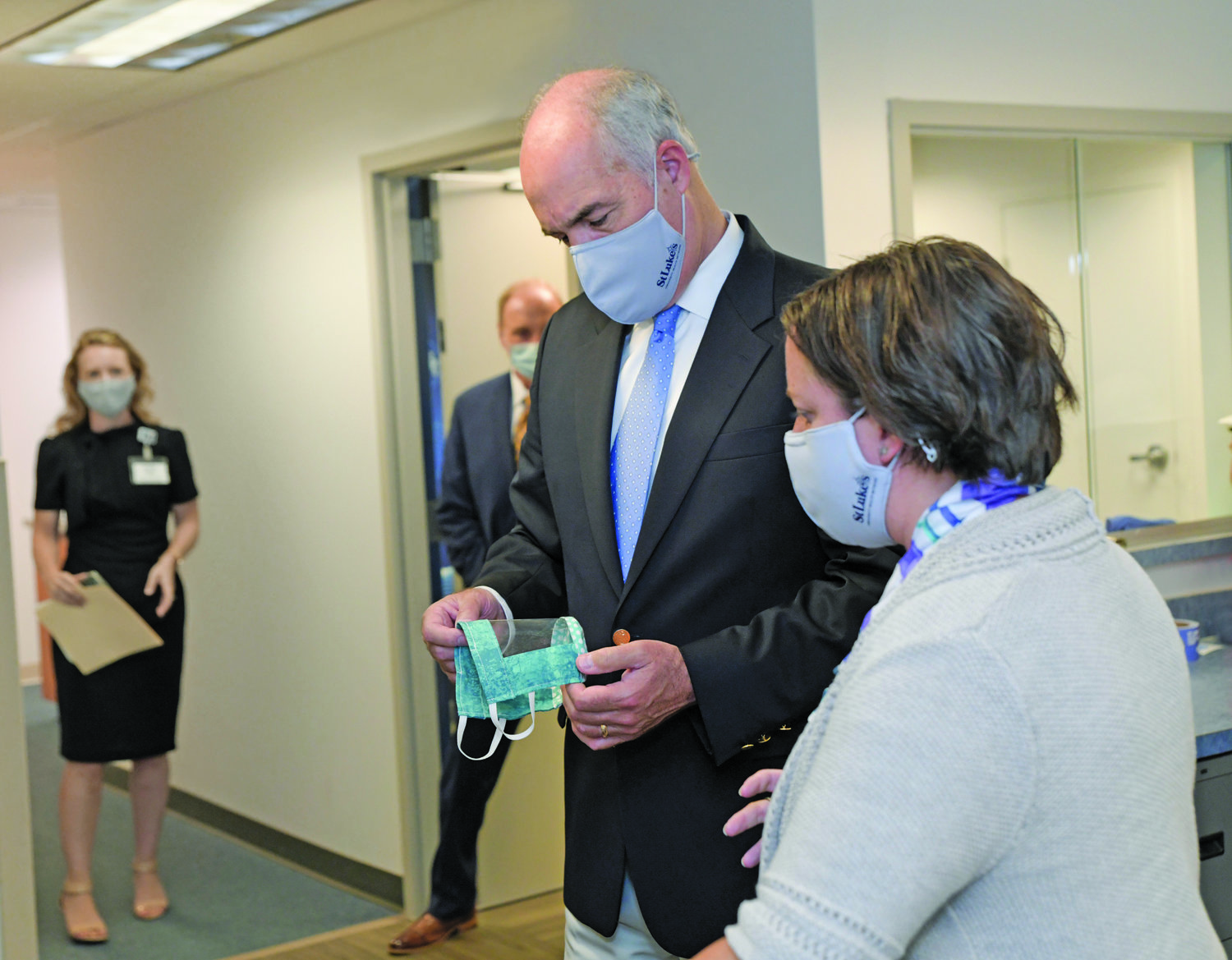 U.S. Sen. Bob Casey examines a 3D-printed mask with Megan Augustine, network director of the Simulation Center.