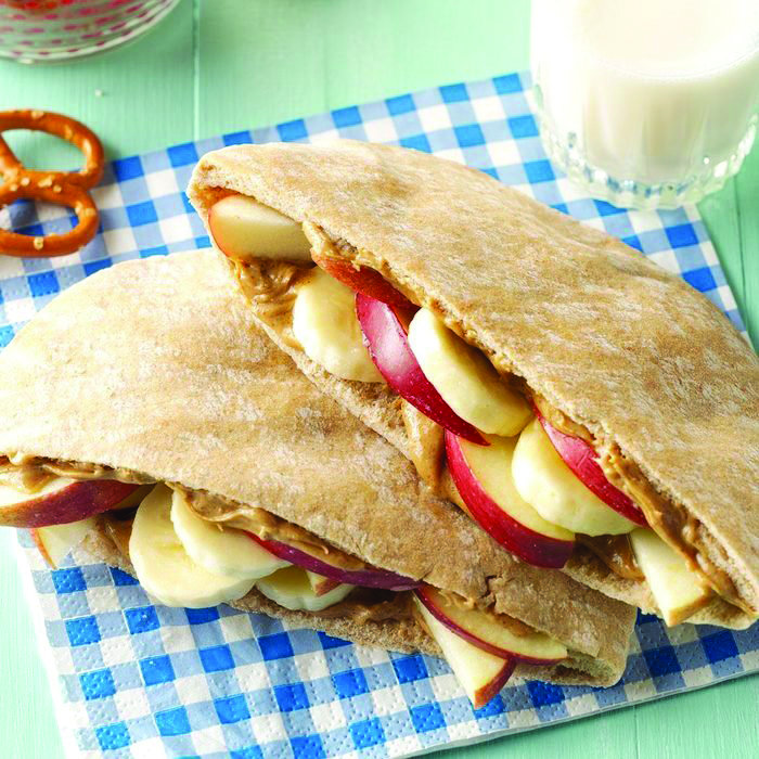 Pitas offer a variation on taste and texture for peanut butter and jelly sandwiches; these use fruit slices in place of jelly.