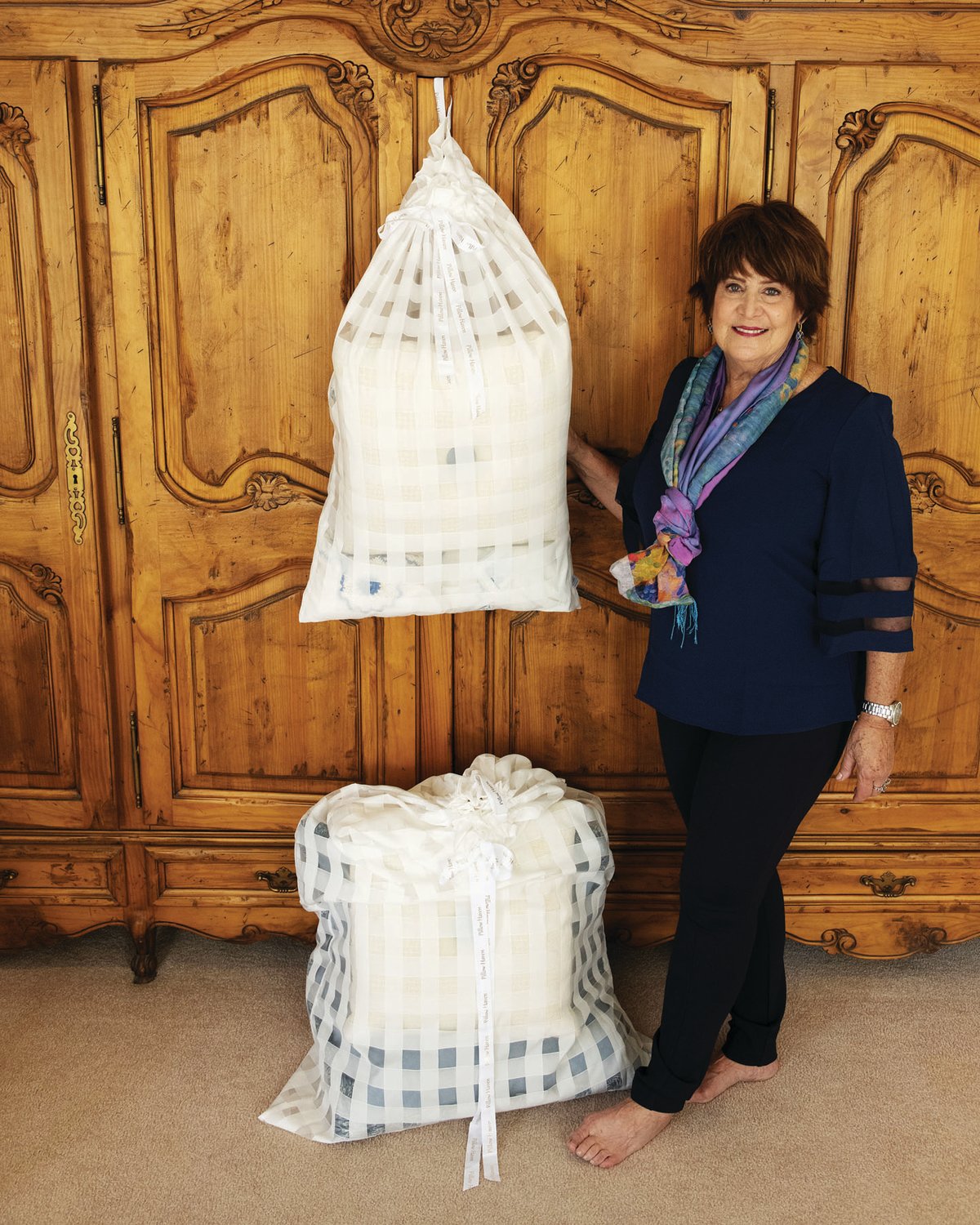 Pillow Haven founder Judy Jacobson with the large and small decorative pillow storage bags.