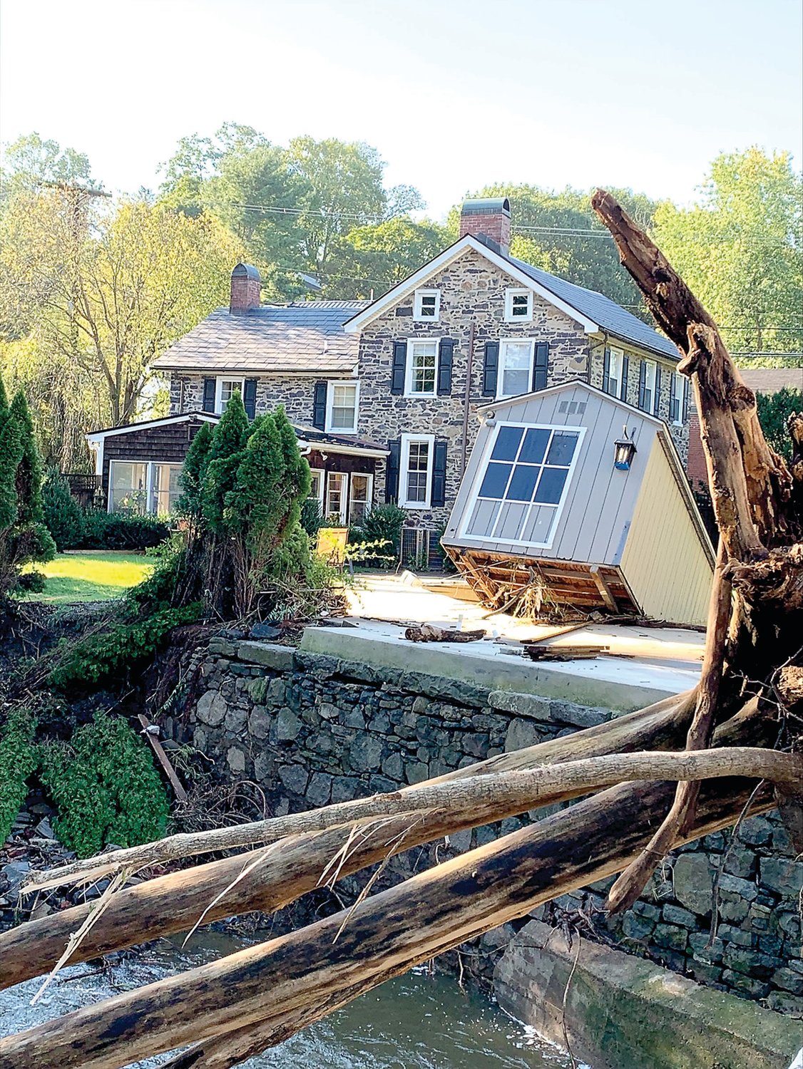 Shed in the pool off South Main Street about to topple into Swan Creek in Lambertville.