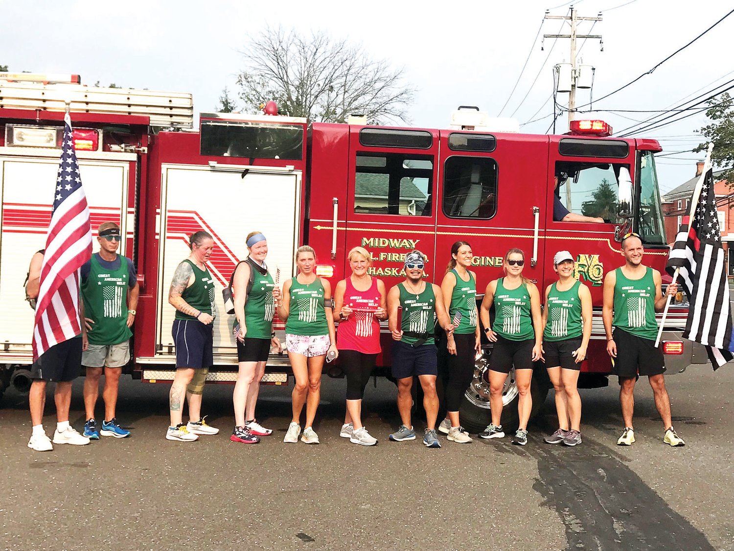 Runners taking part in The Great American Relay stopped on Route 202 in Lahaska to take photographs with members of the Midway Fire Company on Tuesday.