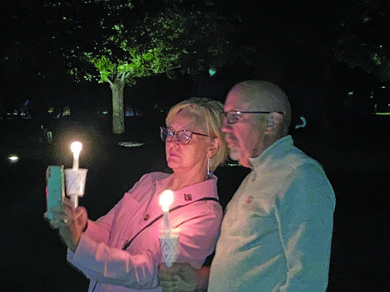Lauren and David DeVido of Holland hold candles Saturday night during the closing candlelight vigil of an evening ceremony in Lower Makefield Township marking 20 years since the Sept. 11, 2001 terrorist attacks.