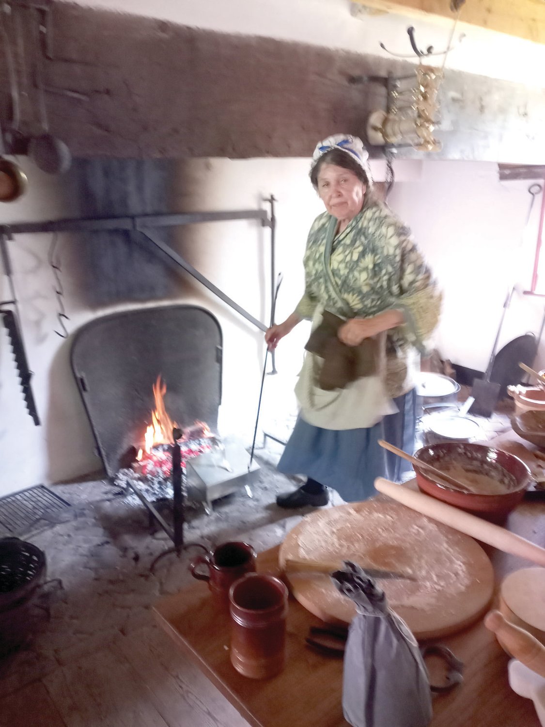 Susan McLellan Plaisted cooks on the open fires at the Moland House.