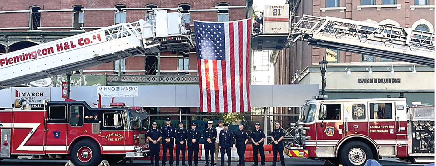 Members of the Flemington Fire Department and Raritan Township Fire Co. raised the American flag for the ceremony.