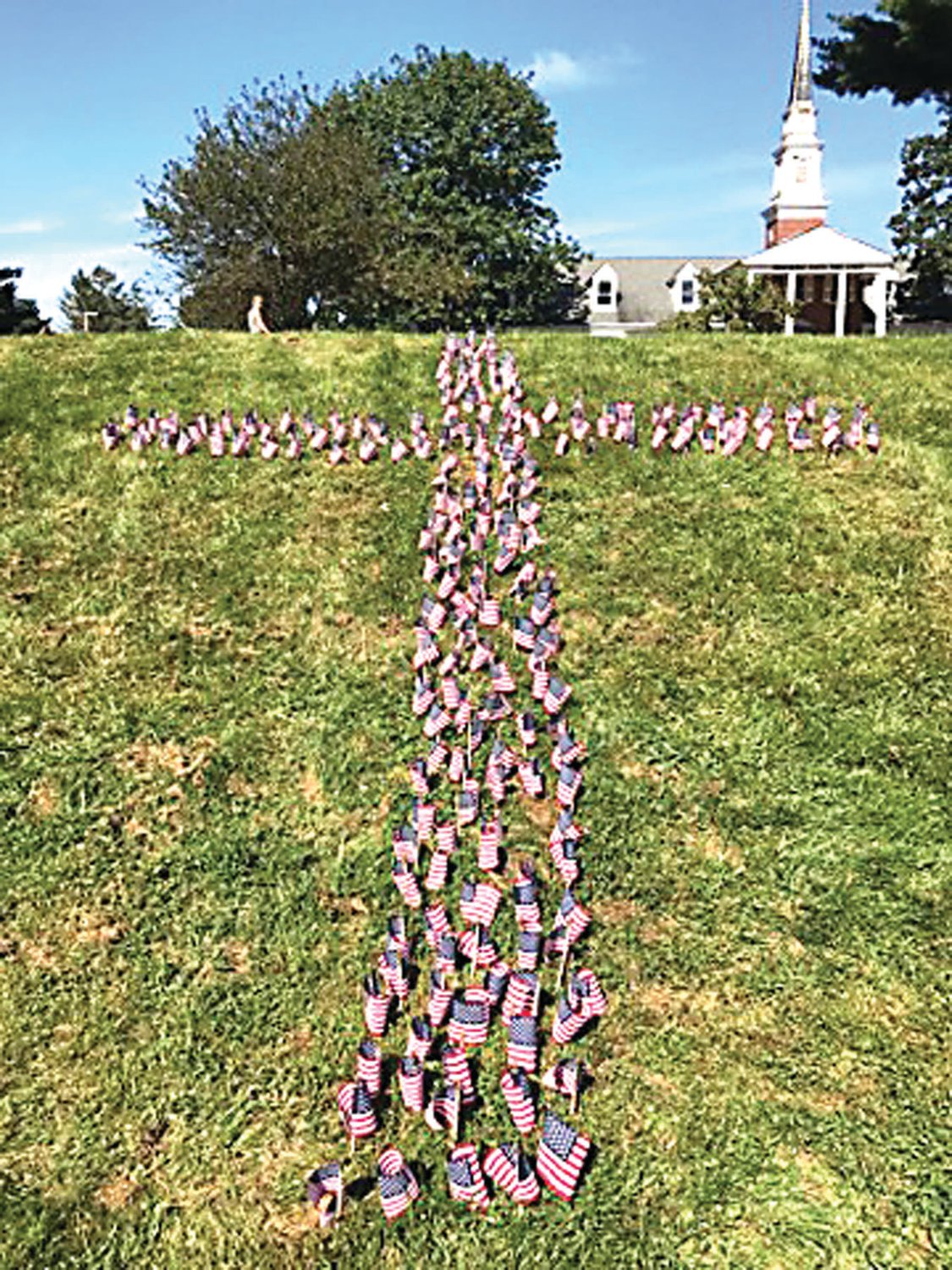 American flags planted in the shape of a cross at The Crossing.