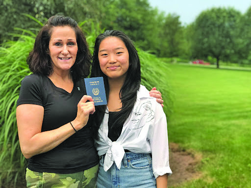 Nicole and her American mom Diane Hudack hold her Korean travel card.