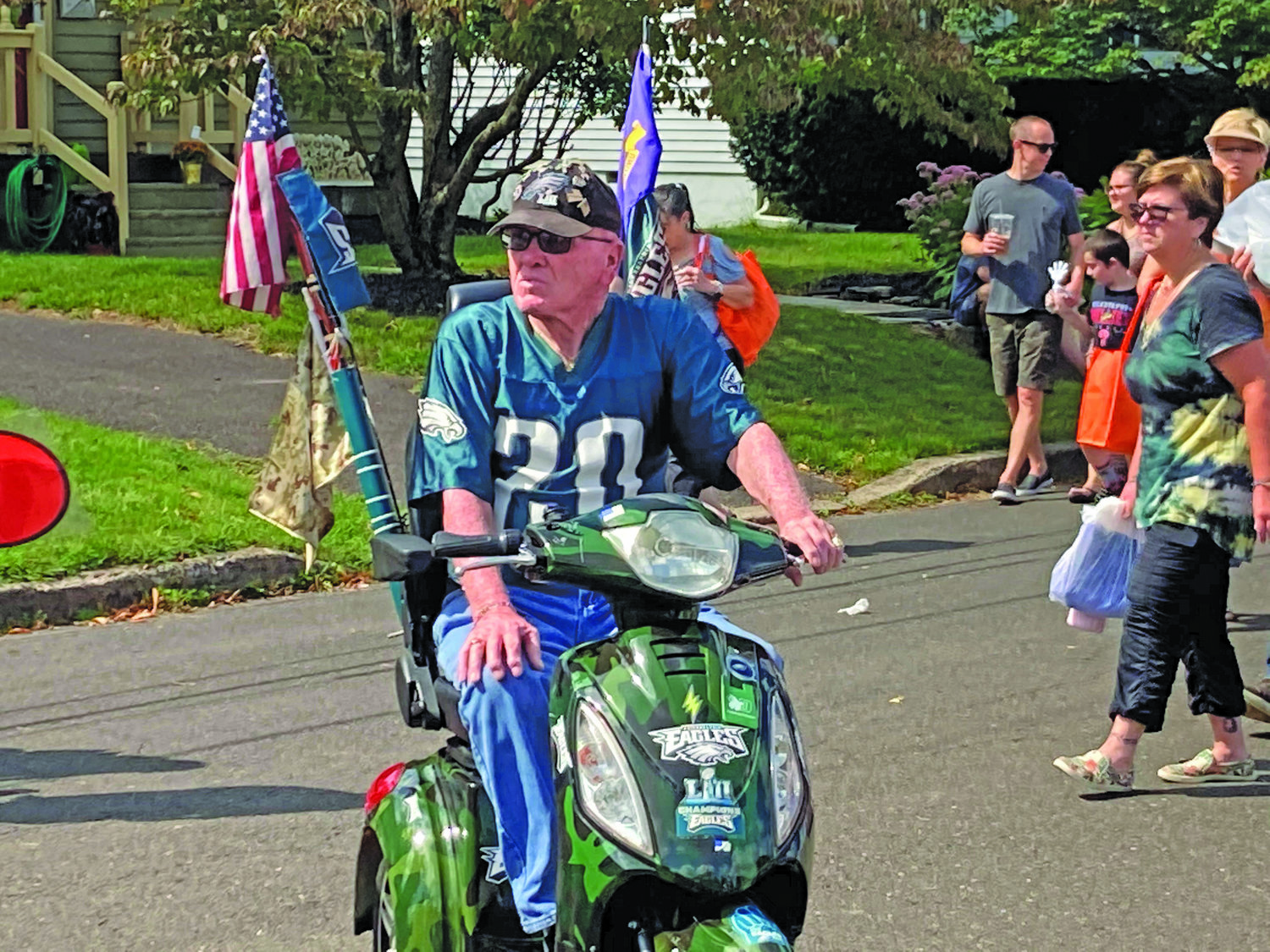 Big Eagles fan Bob Maylie surveys the crowd in his Birds-themed motorized cart during Harvest Day in Yardley Borough.