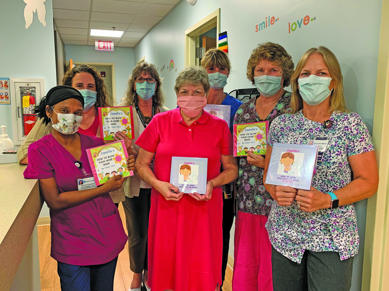 Author Cindy Yard, center, delivers her books to the staff at the Hunterdon Pediatric Associates Sand Hill office located in Flemington, N.J. The books will be available in all five Hunterdon Pediatric Associates offices.