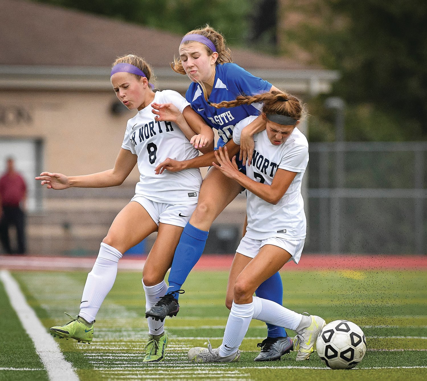 CB South’s Allison Sauers splits the defense of CR North’s Jayne Bogle and Lexi Fischer.