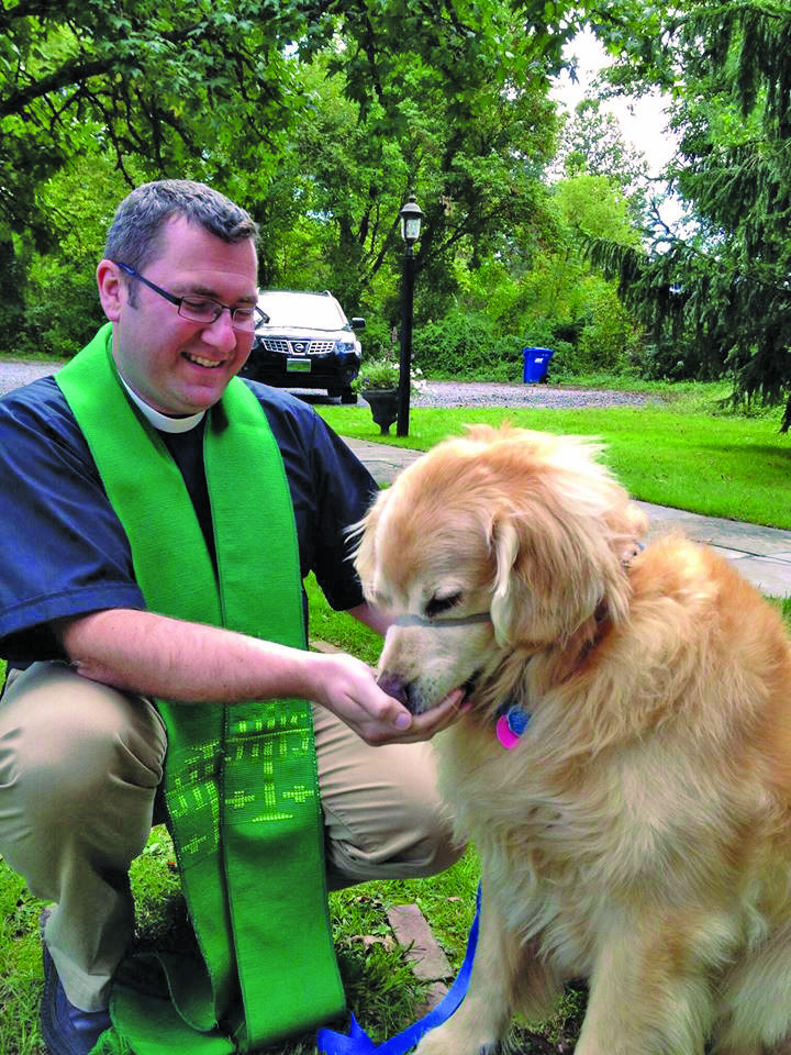The Rev. Michael Ruk, rector of St. Philip’s Episcopal Church, located just outside of New Hope in Solebury Township, visits with a four-legged friend.