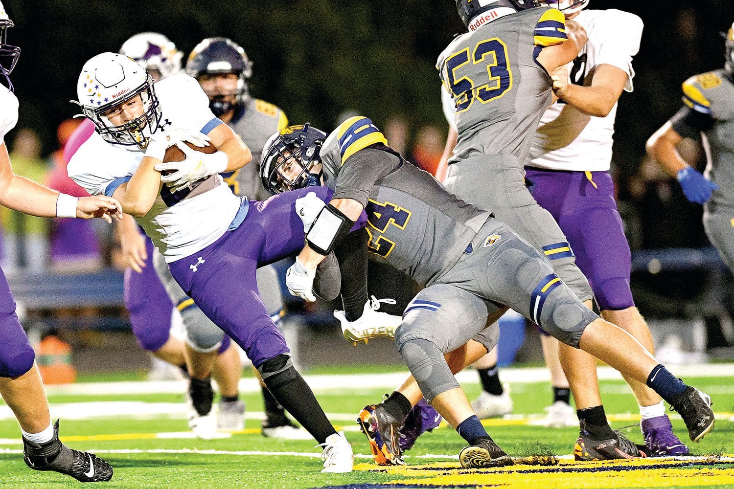 As he makes the tackle, New Hope linebacker Jude Hutkin grabs the leg of Upper Moreland running back Tomas Carr.
