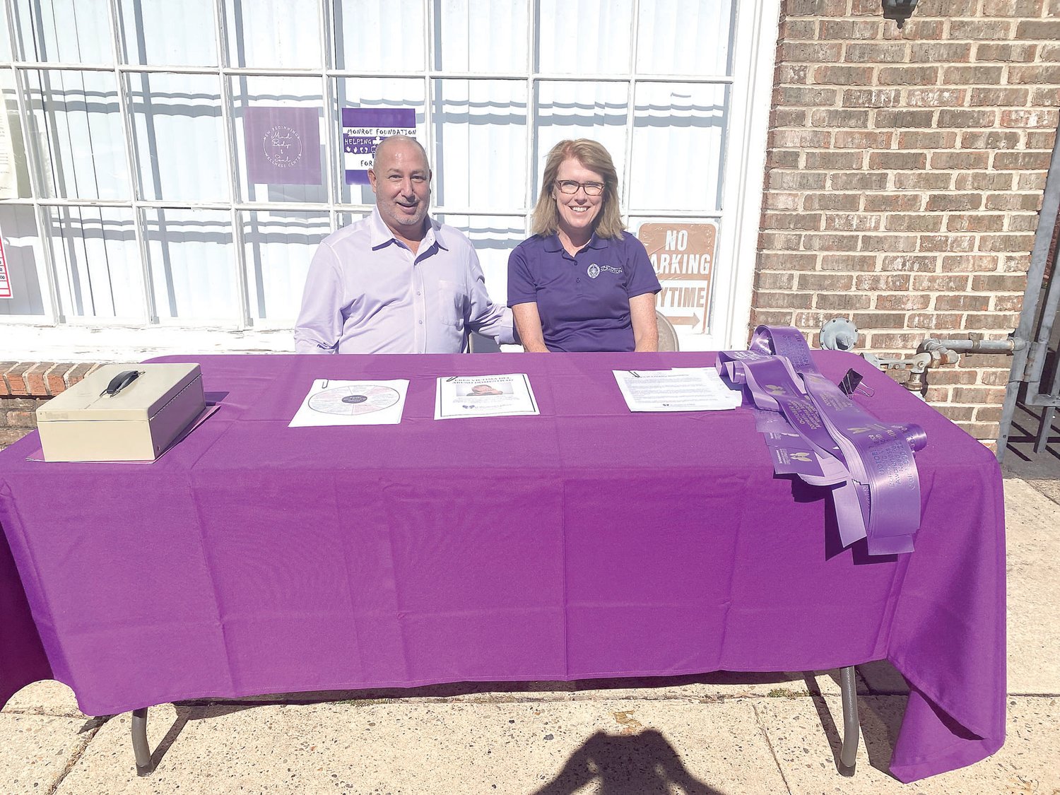 Marjie Devlin and Jay Glickman spread awareness about domestic violence during A Woman Place’s Pint the Town Purple event in Bristol.