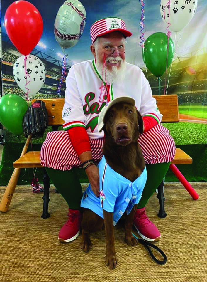 Santa visits with a dog daycare client.