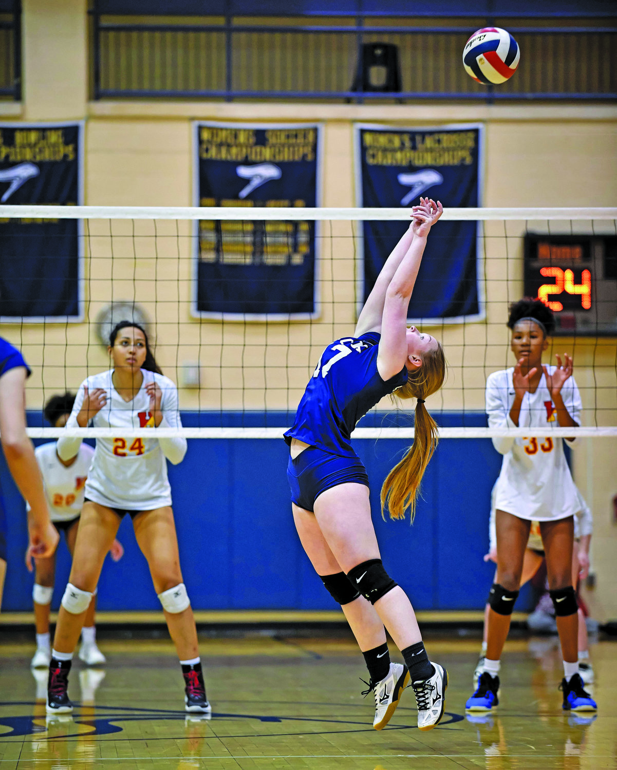 CR South’s Lili Lauch stretches to set up a spike.