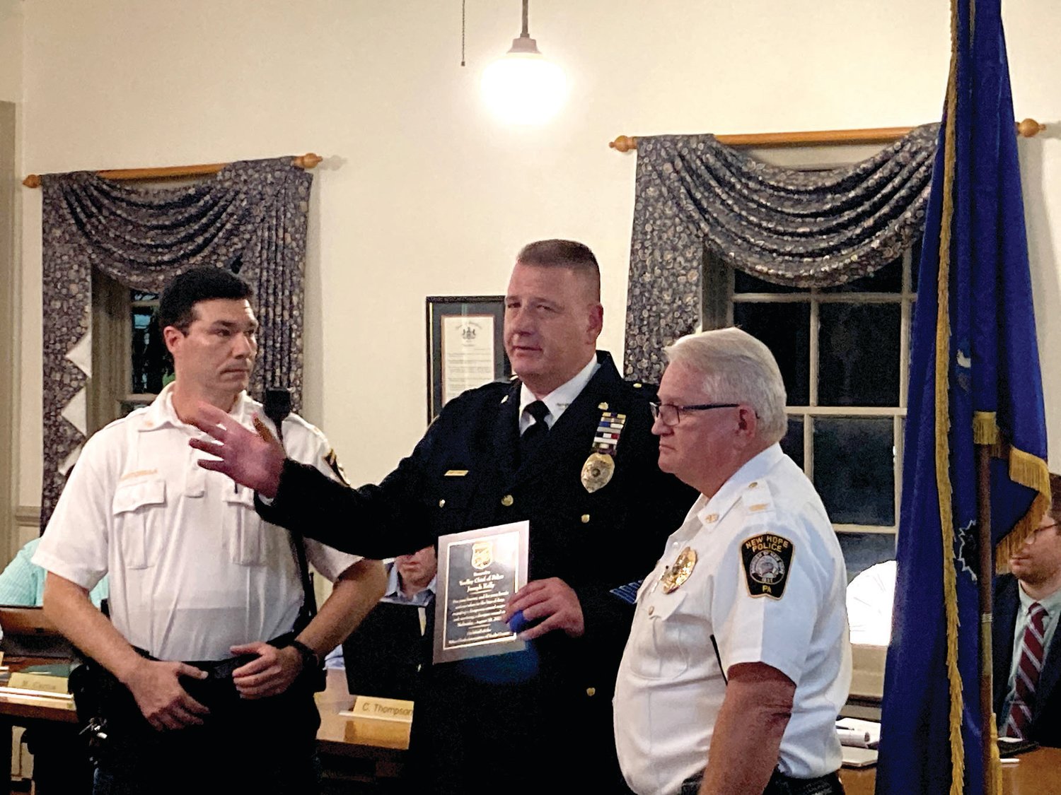 Yardley Borough Police Chief Joseph D. Kelly III, center, accepts an award at the Oct. 19 council meeting presented by Police Chiefs Association of Bucks County President and New Hope Borough Police Chief Mike Cummings, right, and Middletown Township Police Chief Joseph Bartorilla.