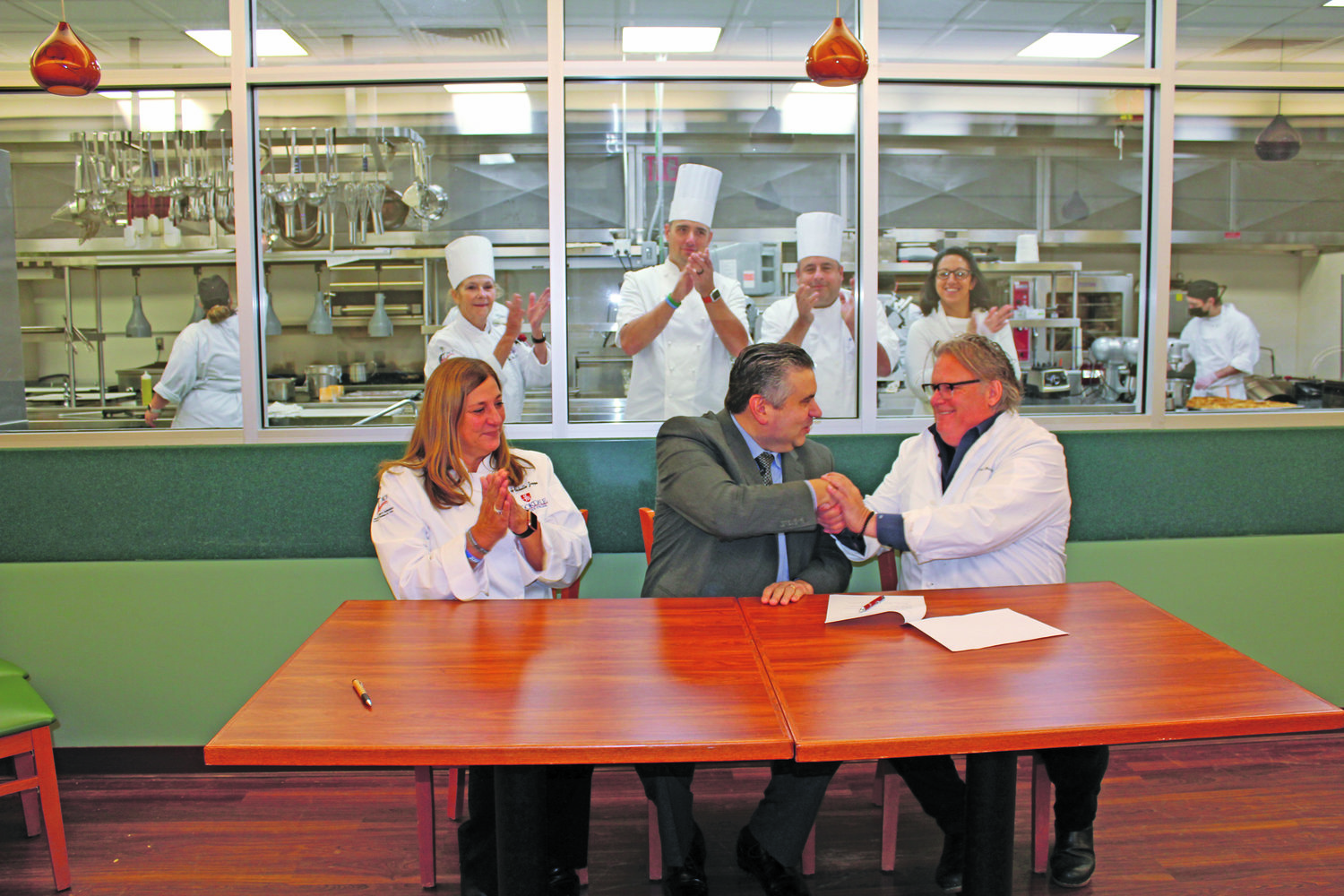 Chef David Burke and Dr. David Stout of Brookdale Community College Foundation sign a Memorandum of Agreement to establish the Chef David Burke Scholarship.