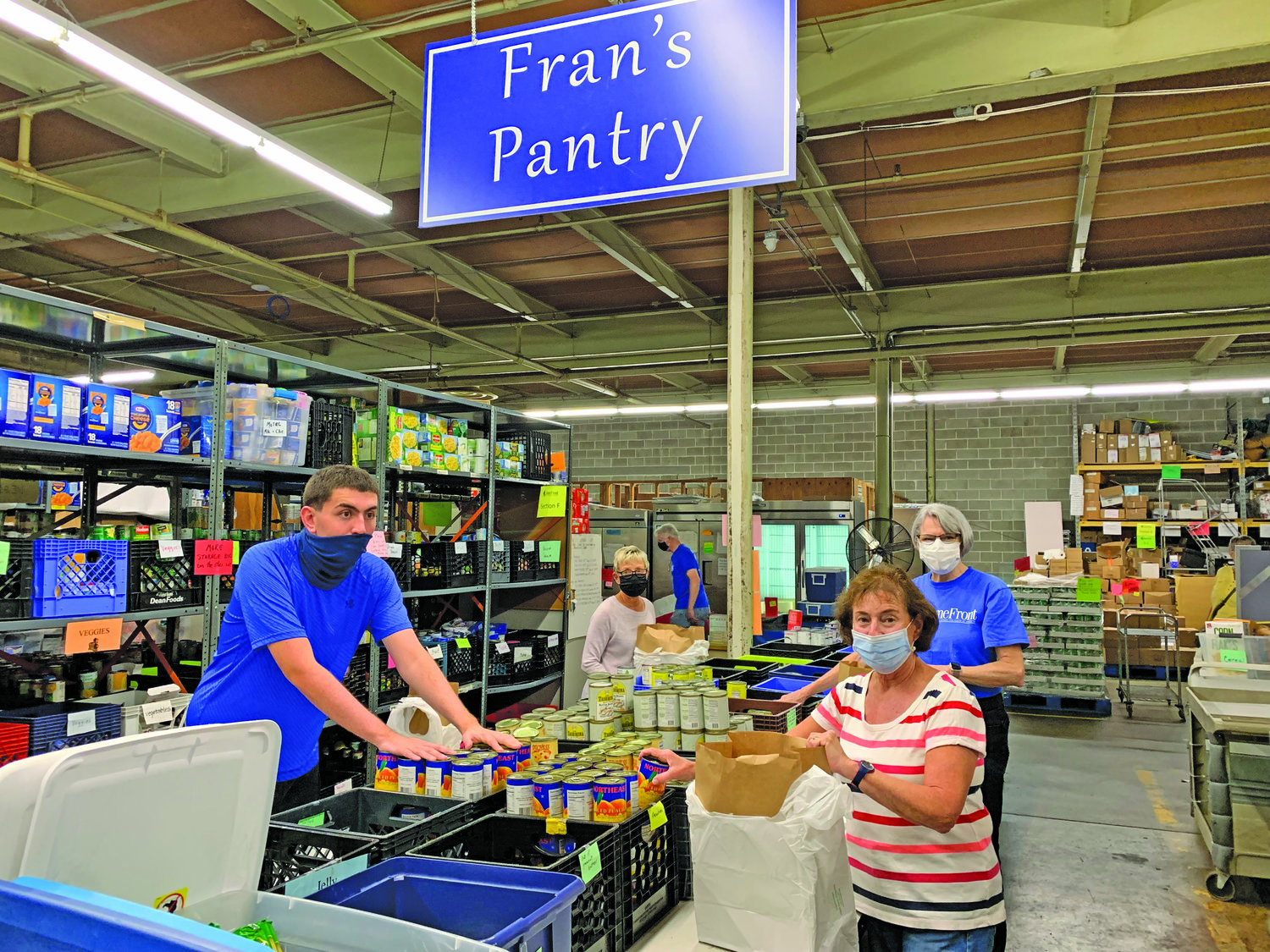 Community members volunteering in “Fran’s Food Pantry” at HomeFront, including Barbara Carberry from Yardley, back left,,  Hunter Elkins, front left, Madeline Lightman, front right,  from WW-P, and Donna Famoso, back right,  from Hamilton Square.
