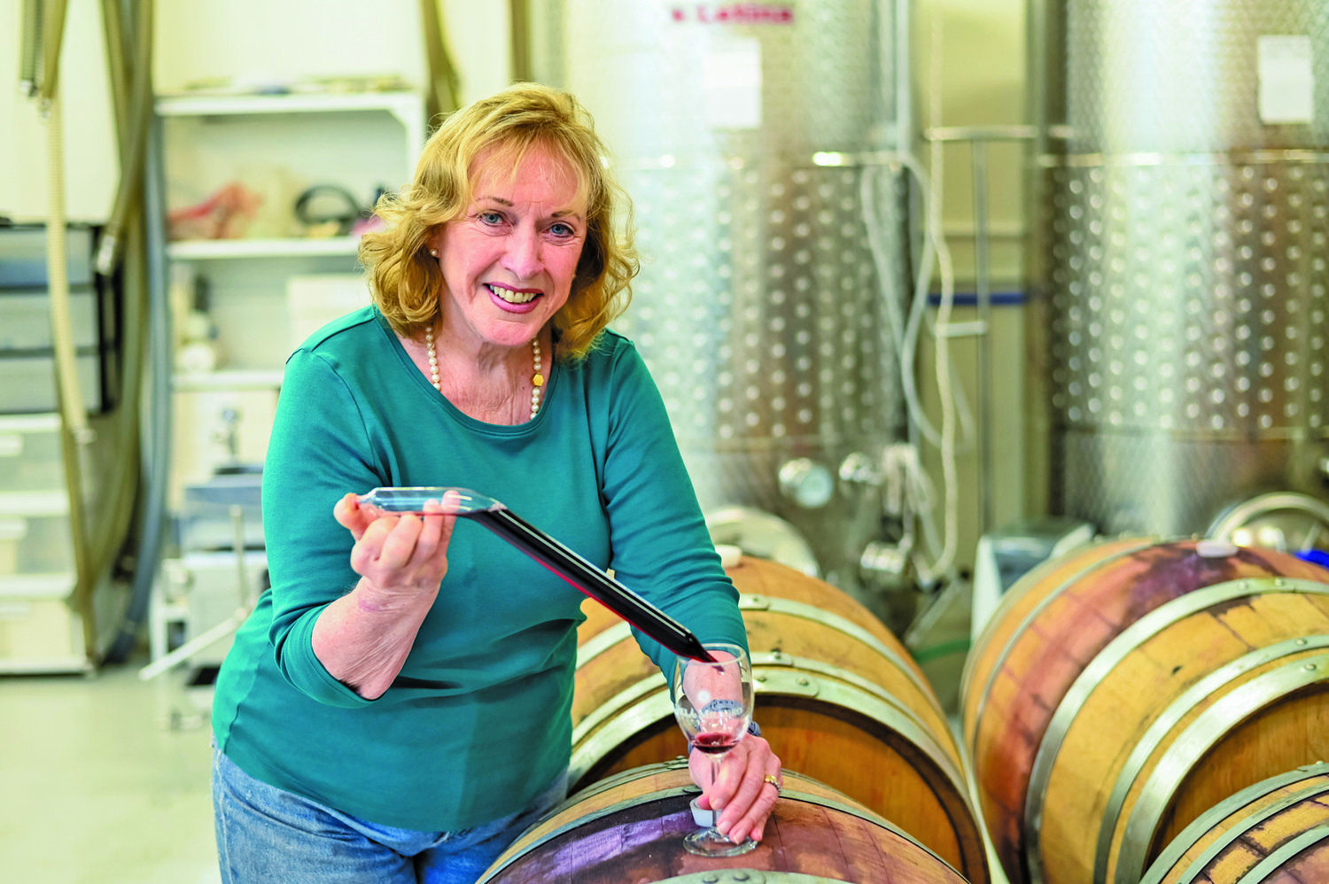 Dr. Audrey Cross taps a barrel in the hilltop winery she and her husband, Stephen Gambino, own in Finesville, N.J., just across the Delaware River from Riegelsville.