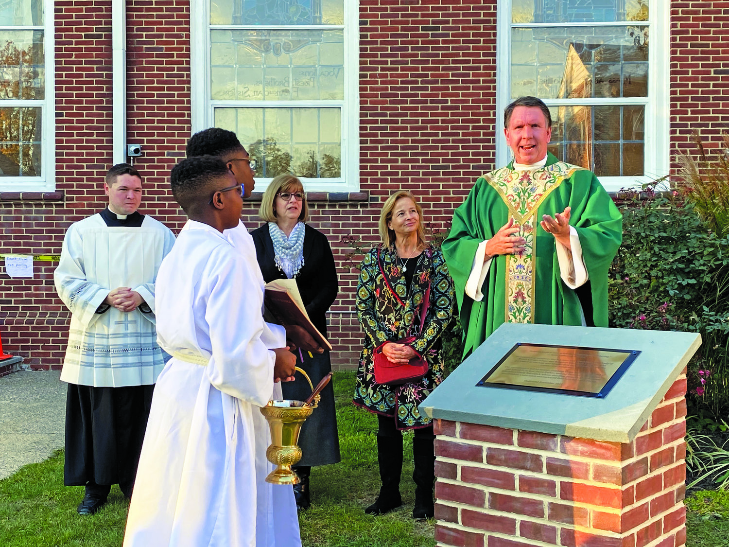 Back, from left, are: the Rev. Matthew D. Brody, parochial vicar; Cindy Balceniuk, director of religious education; Dawn Parker, school principal; the Rev. Matthew W. Guckin, pastor. In the foreground are: Jeremiah and Jason Ofori-Mensah, altar servers.