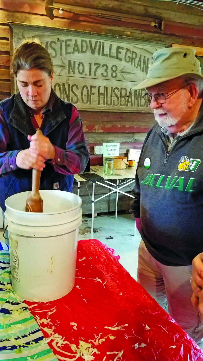 Jim Diamond, a local expert on making sauerkraut, offers direction to “sheep lady” Anita Duscher.
