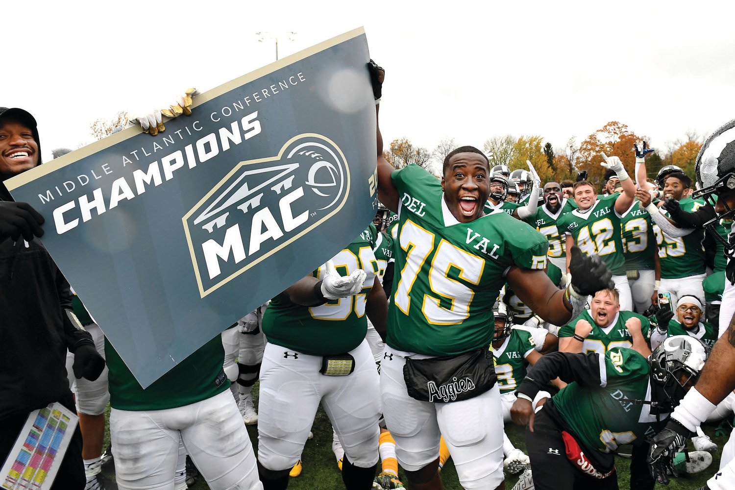 Delaware Valley University football players celebrate winning their fourth consecutive MAC title.