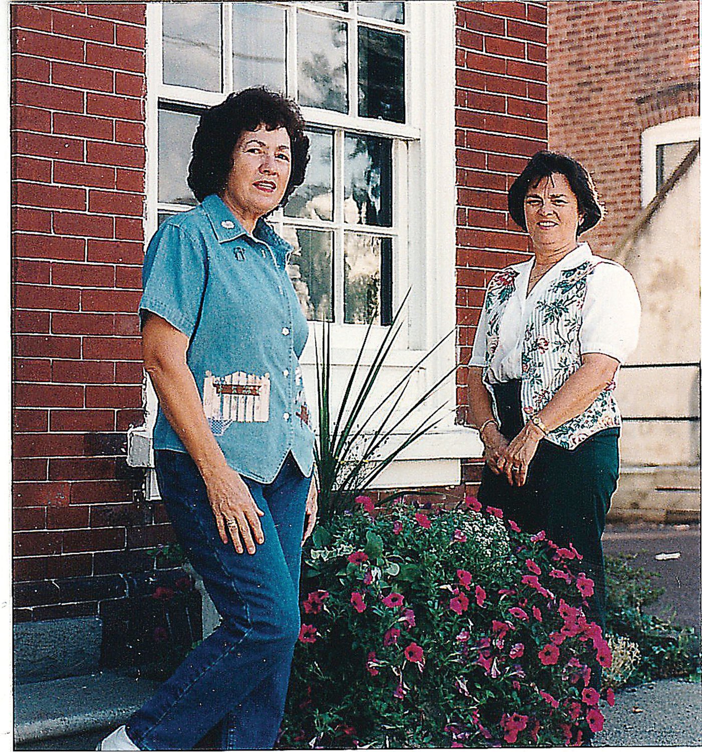 Elsie Bartram and Linda List were photographed, as part of an article in the Perkasie News-Herald when the Perkasie Garden Club was awarded second place for planters in the Community Container Garden Category of the Bucks Beautiful 1997 Summer Competition. Elsie was president of the club and Linda was the club member who spearheaded the planters project, their installation and planting.