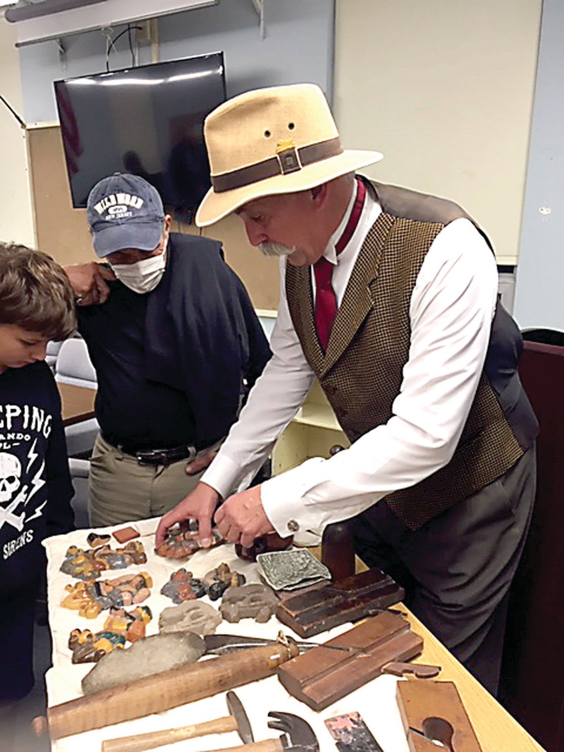Actor Jamison Bradley, portraying Henry Chapman Mercer, displays some of his favorite tools for those attending his presentation for the Haycock Historical Society.