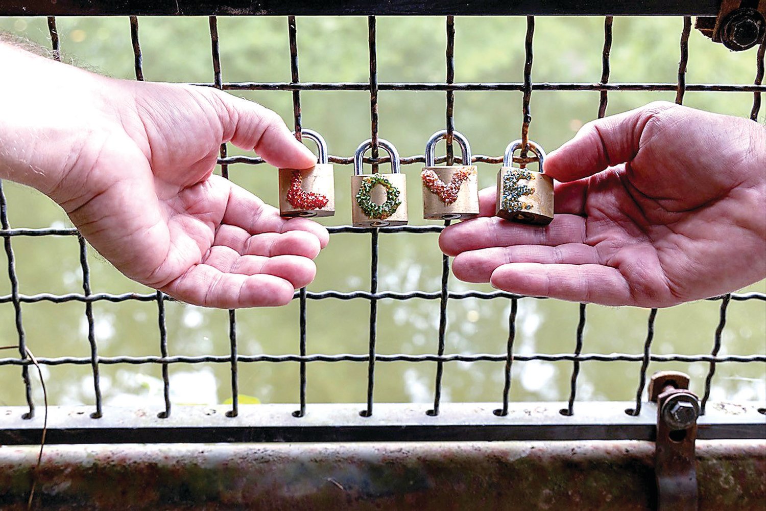 Two hands that lovingly create and care for the Lambertville Love Locks Bridge.