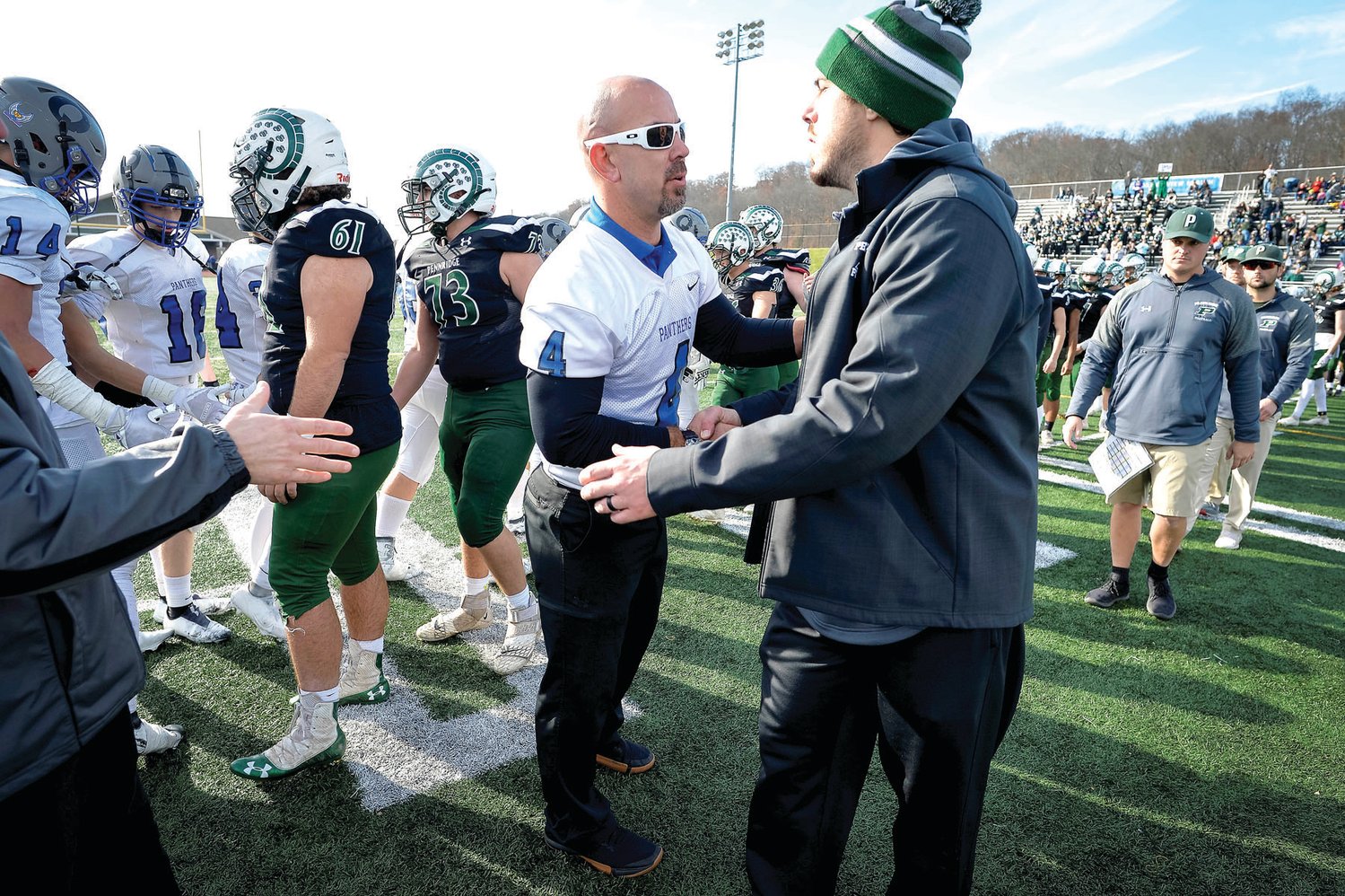 The coaches shake hands at midfield after Quakertown shut out Pennridge 21-0.