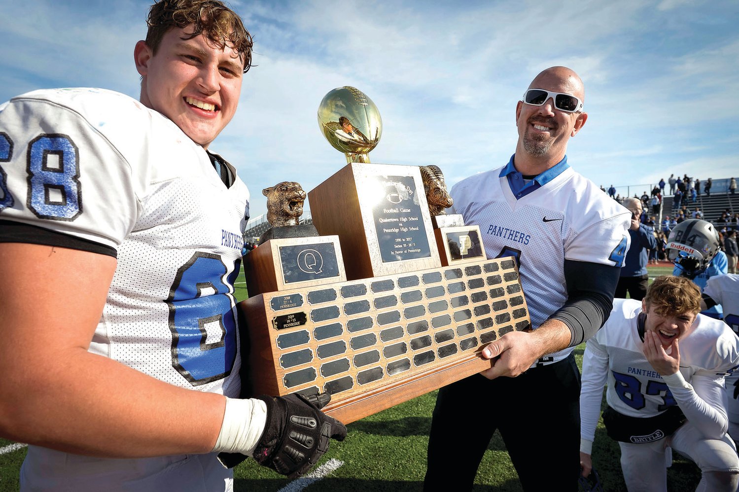 Quakertown’s Blake Griesemer and coach George Banas are all smiles with the trophy.