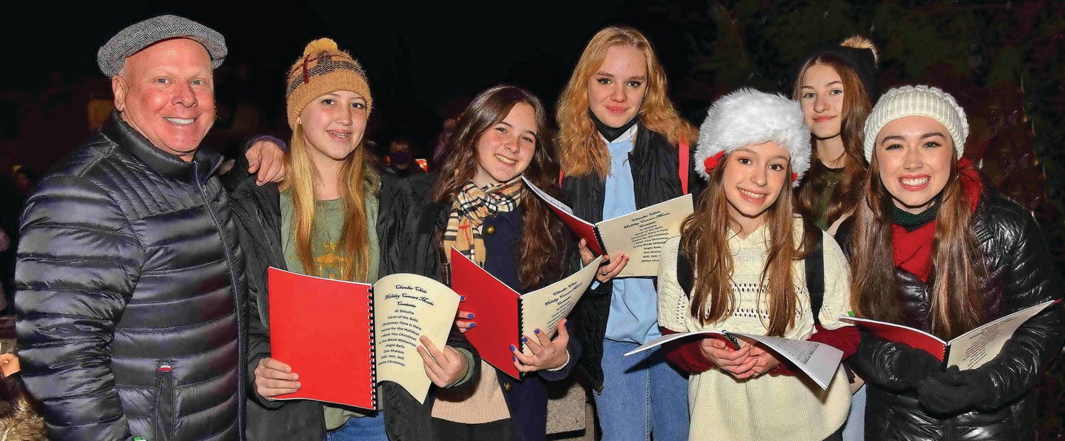 New Hope-Solebury High School Chamber Choir, directed by Tim Bateman, left, provides entertainment with carols.