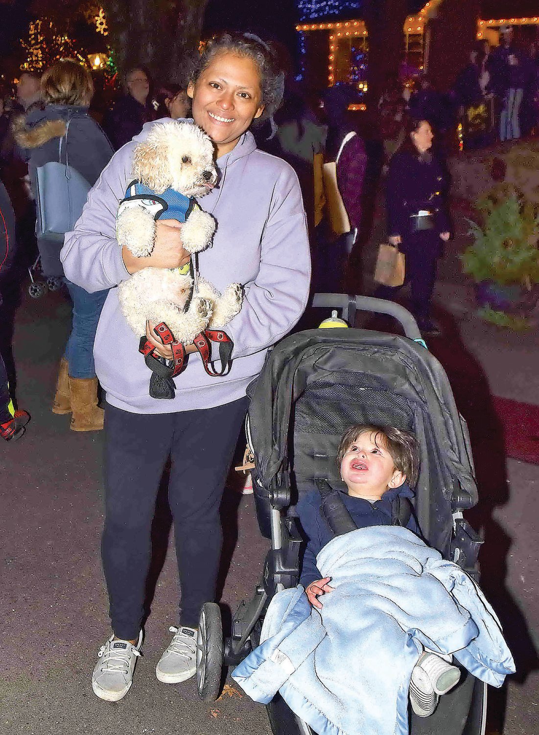 Maria Audelo holding Harvey (dog), Ali (11 months) in carriage.