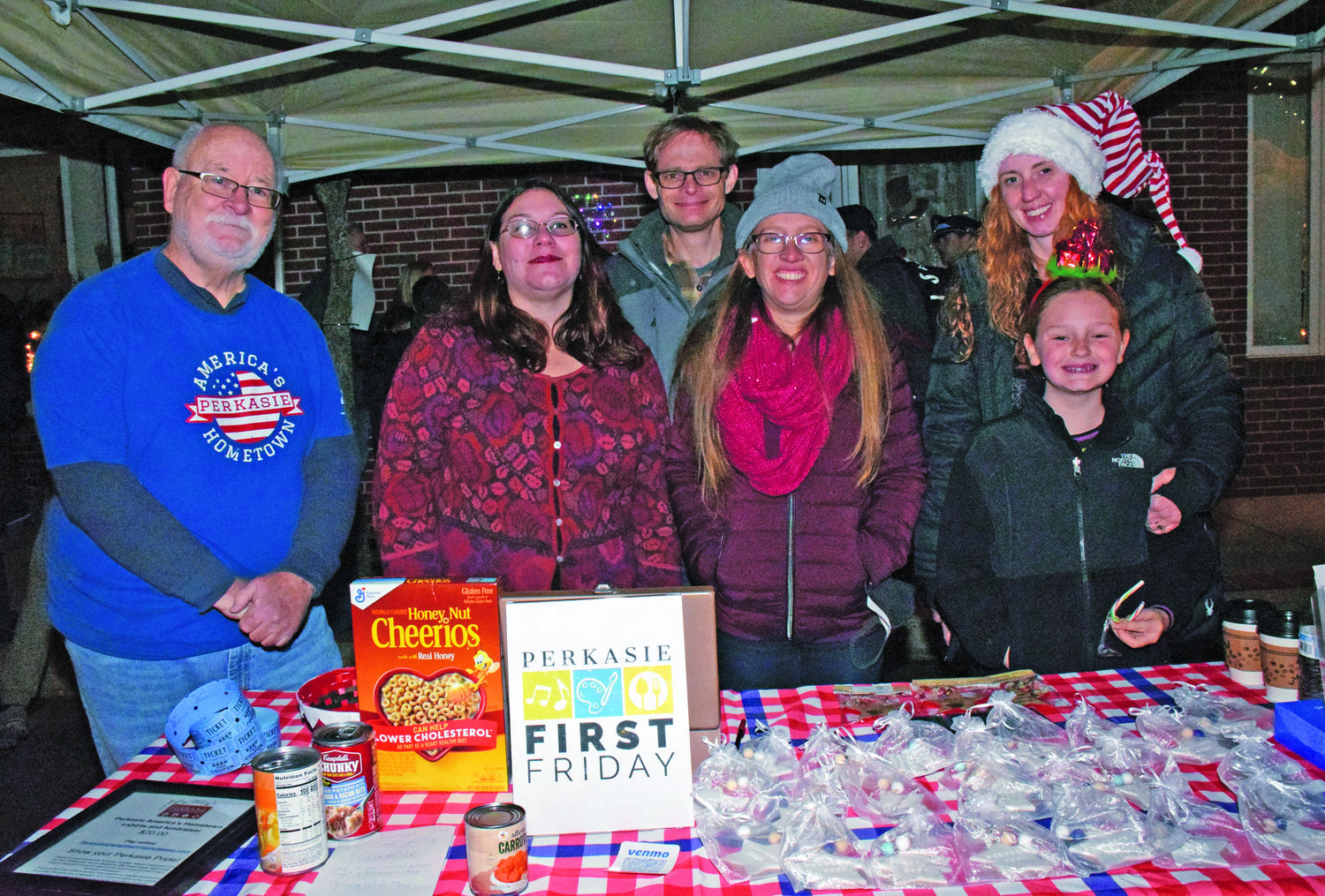 Joe Ferry, director of Perkasie Towne Improvement Association, and a team of helpers oversee a food donation fundraiser table.