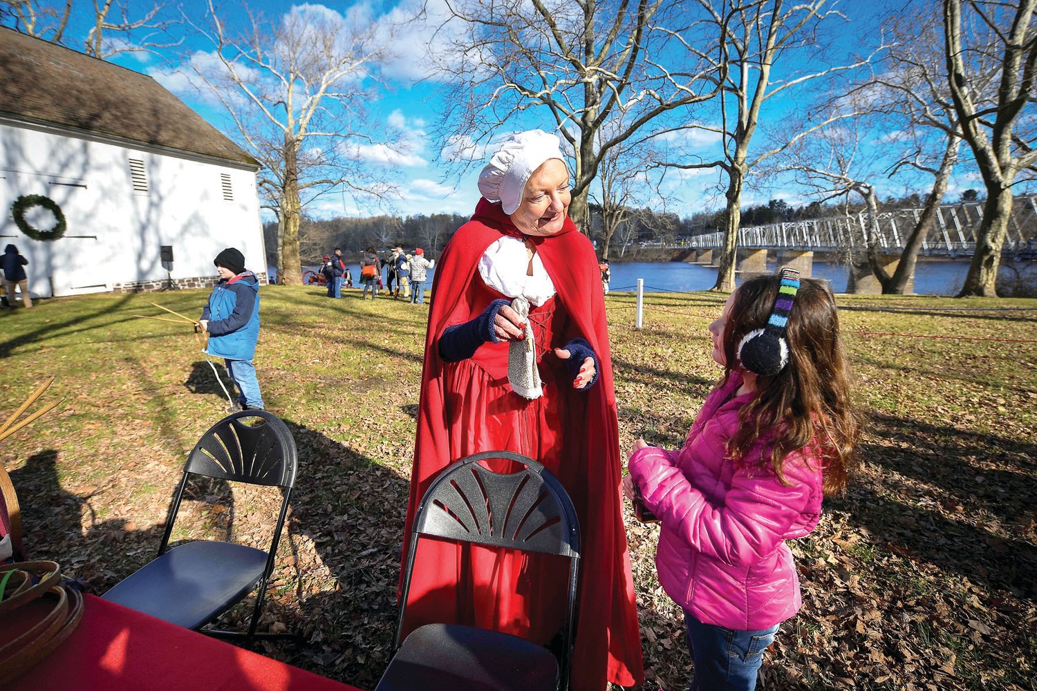 Grace Basler, 7, stops and talks with a Friends of Washington Crossing volunteer.
