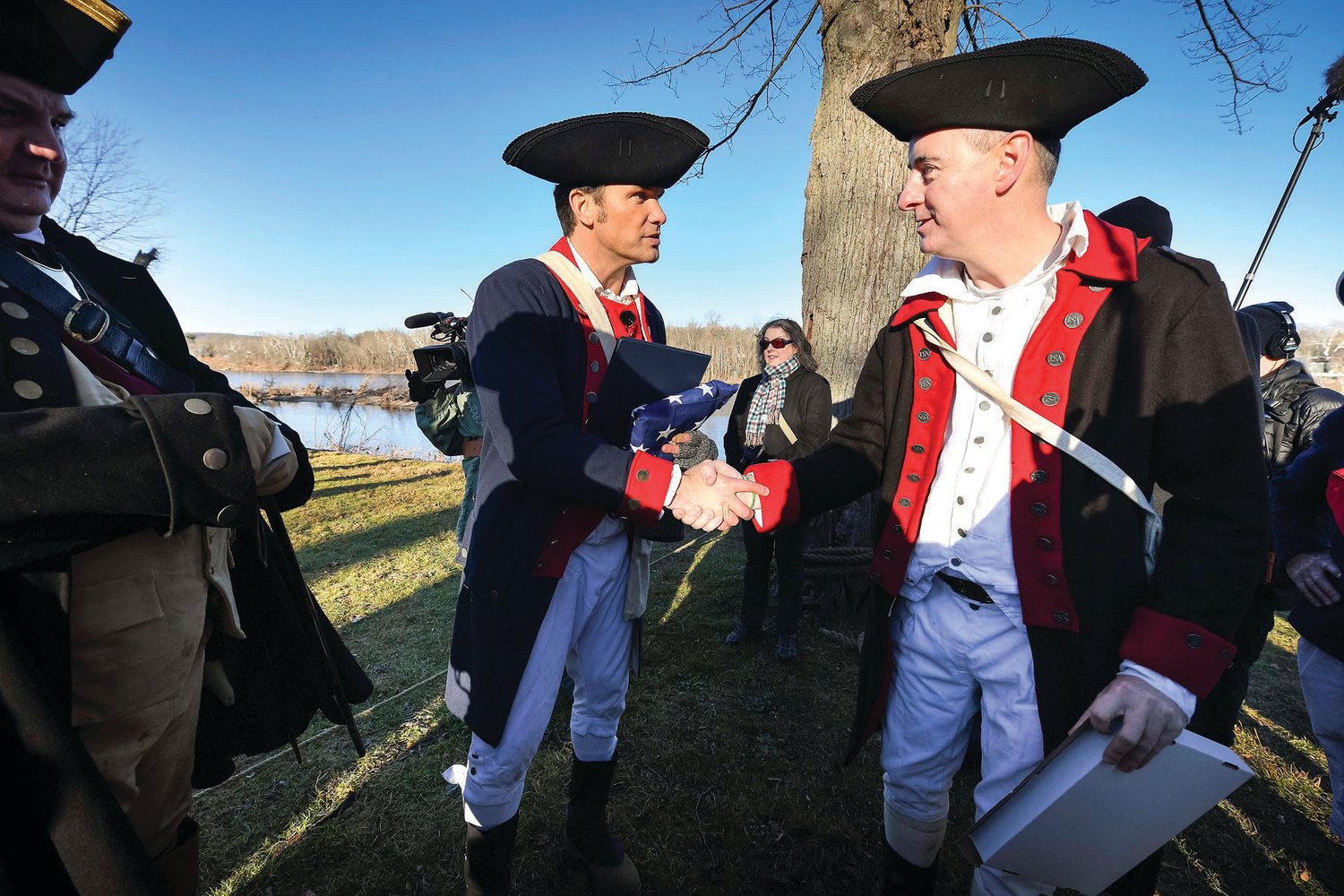 Crossing narrator and Fox News contributor Pete Hegseth, left, is gifted an American flag from the Friends of Washington Crossing Park. Hegseth wore a traditional uniform, and stayed well past the closing ceremony to sign autographs, take pictures and shake hands.