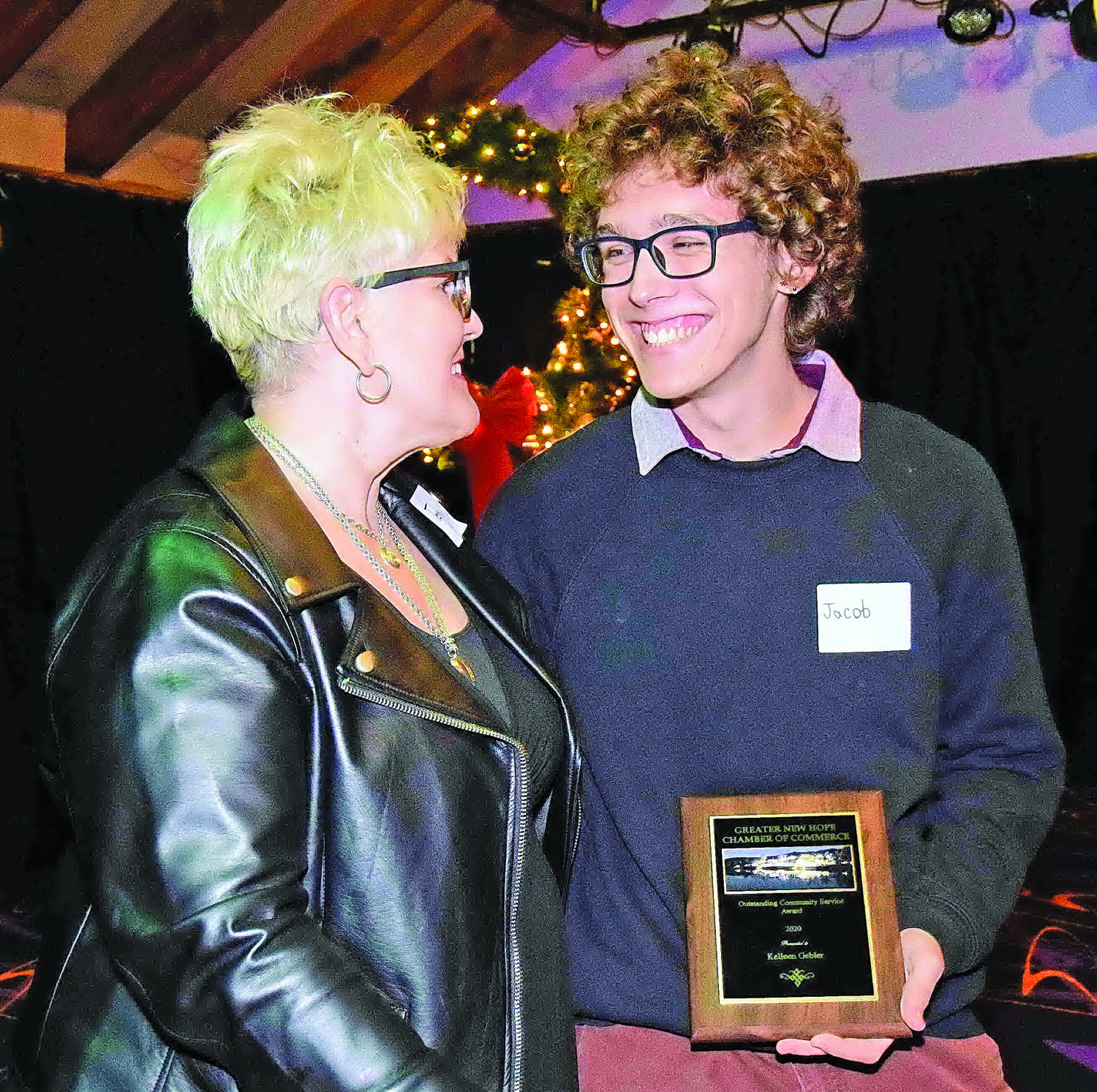 Accepting the 2020 Outstanding Community Service Award for Kelleen Gebler, Go to Concierge, is her son Jacob.