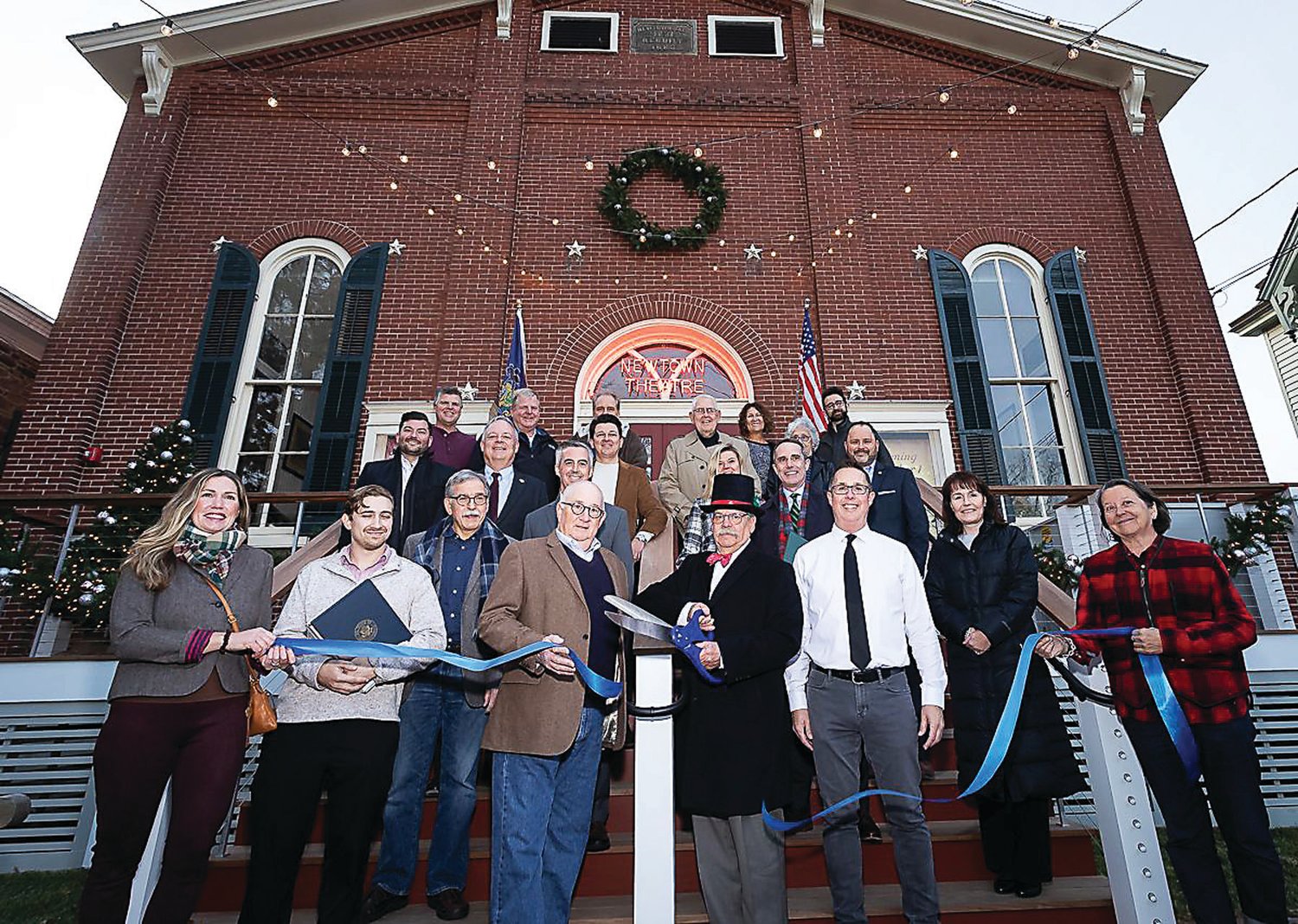 The ribbon-cutting for the newly renovated Newtown Theatre takes place on the theater’s new front steps.