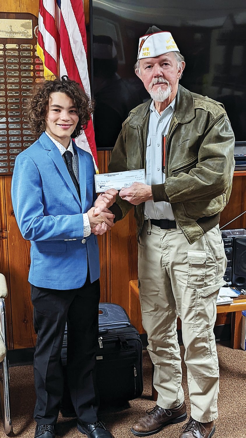 Henry Brusca, an eighth grader from Lambertville, N.J., is presented a check for $200 from the VFW District 19 Commander Georg Hambach.
