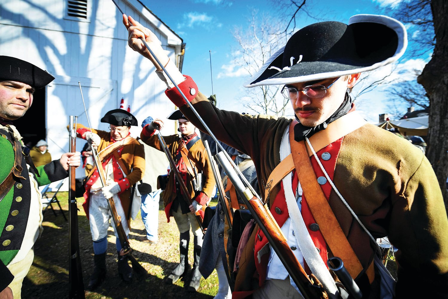 The troops prepare their muskets with blank ammo before marching into position.