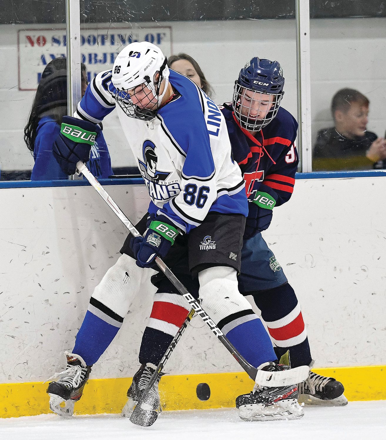 CB South’s DJ Lindenmuth and CB East’s Nick Young mix it up in the corner while battling for the puck.