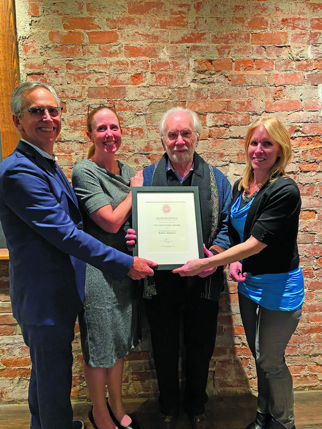 With the award are Michael Raphael, owner of Raphael Architects; Mairi Schuler, president of AIA Bucks County Chapter; Joel Levinson, juror; and Linda Szpak, Raphael Architects project manager.