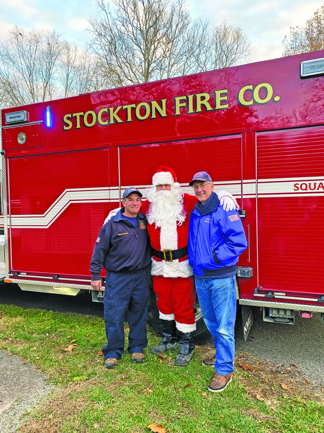 With a Stockton Fire Co. truck are Eric Trautman, Rick McDaniel as Santa, and Karl Darby.