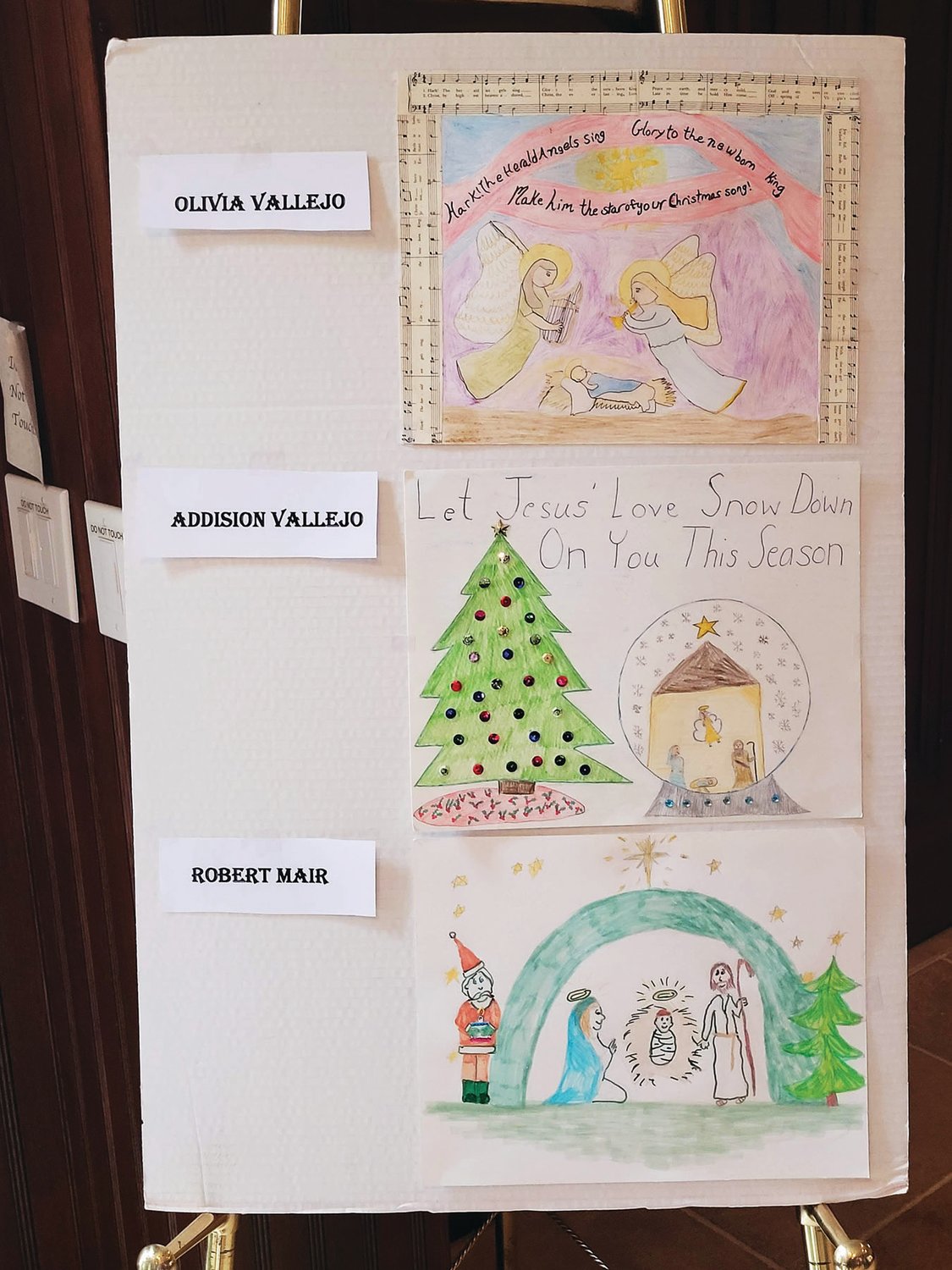 The winning posters in the St. John the Evangelist Knights of Columbus Council 10024 “Keep Christ in Christmas” poster contest.